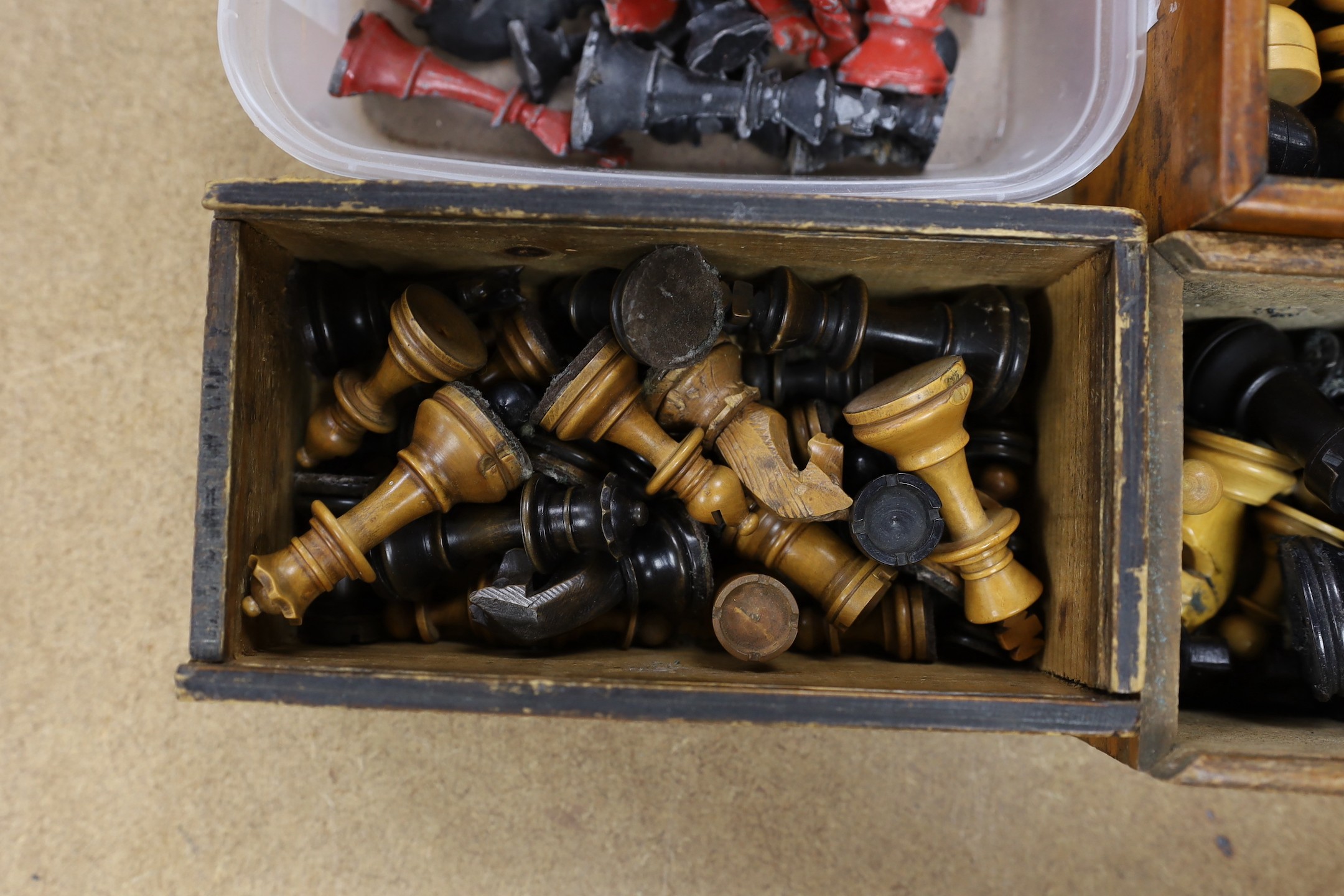 A painted lead chess set together with three boxed turned wooded chess sets.